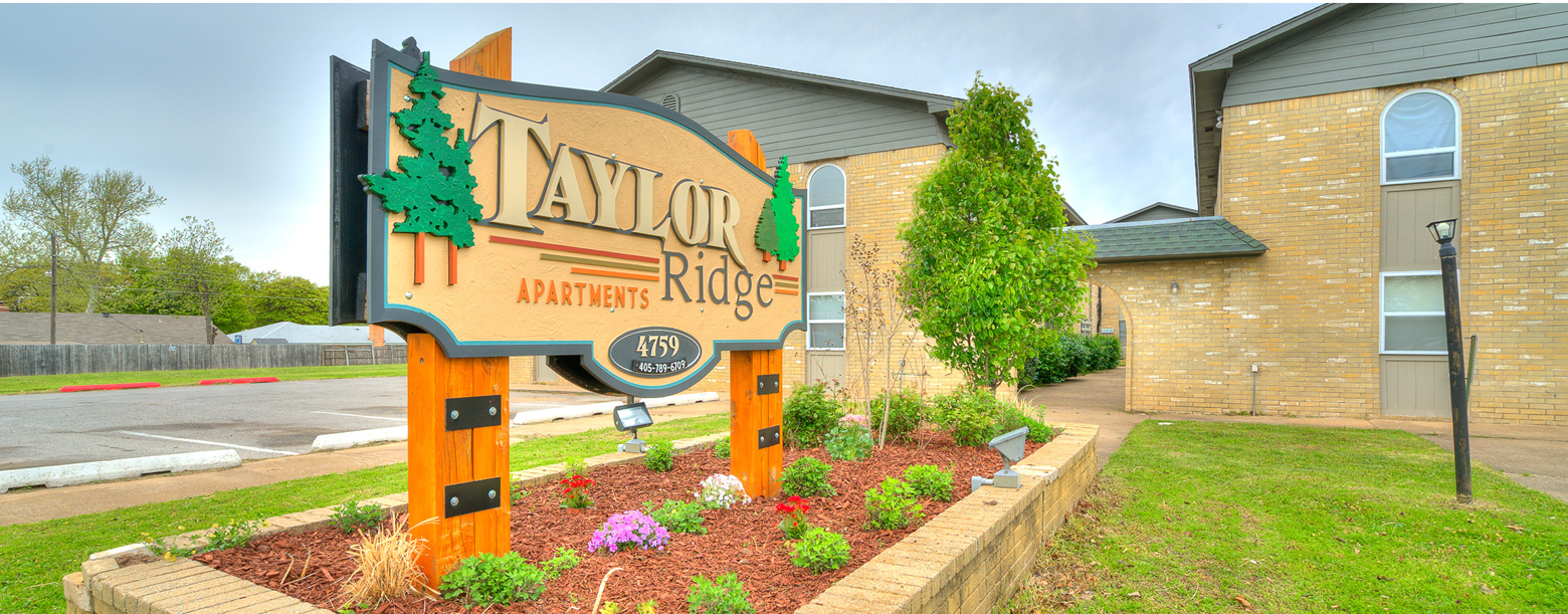 Signage of Talor Ridge with an entrance and parking lot.