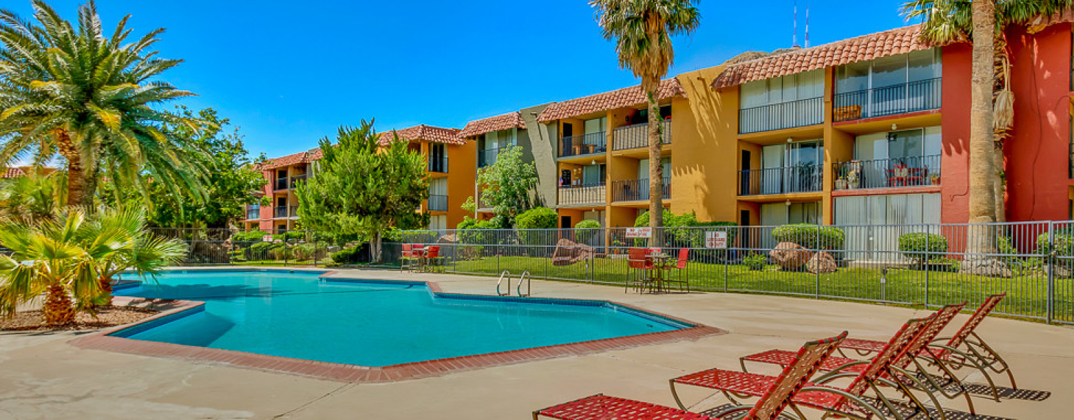 Poolside view featuring palm trees and the buildings of one of the properties comprising the El Paso Portfolio.